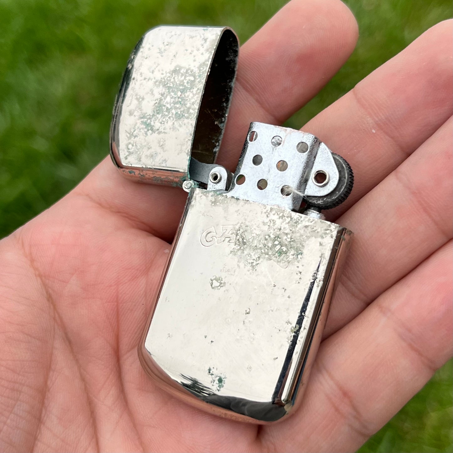 Vintage weathered Camel flip lighter.