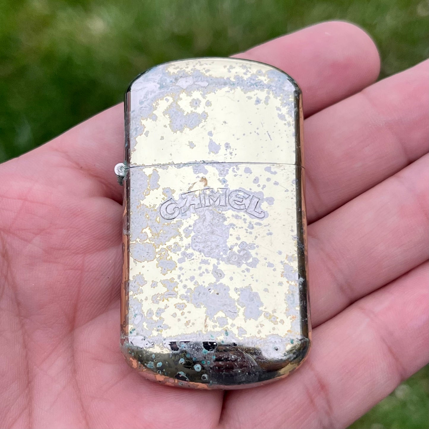 Vintage weathered Camel flip lighter.