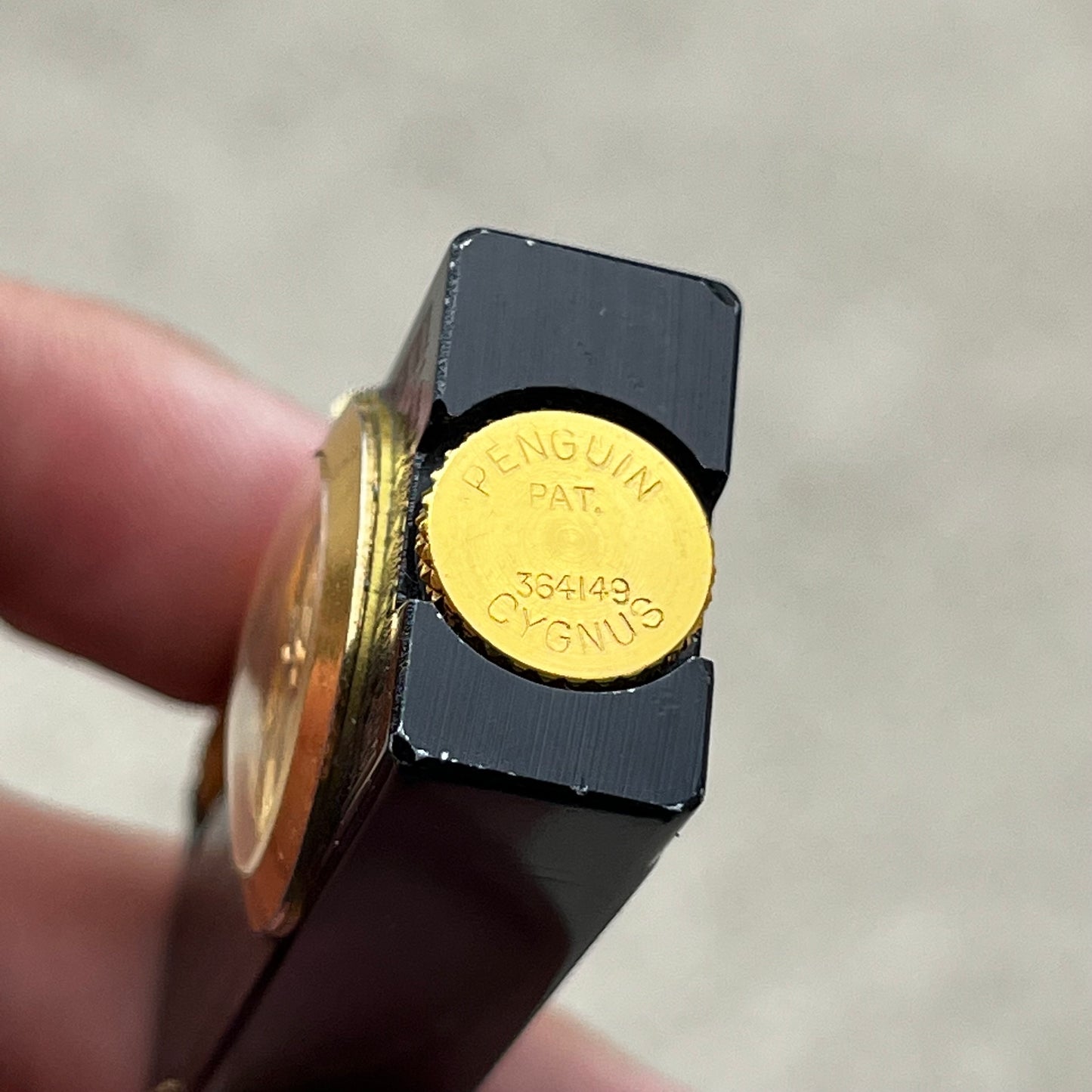 1950s Penguin Cygnus clock lighter.