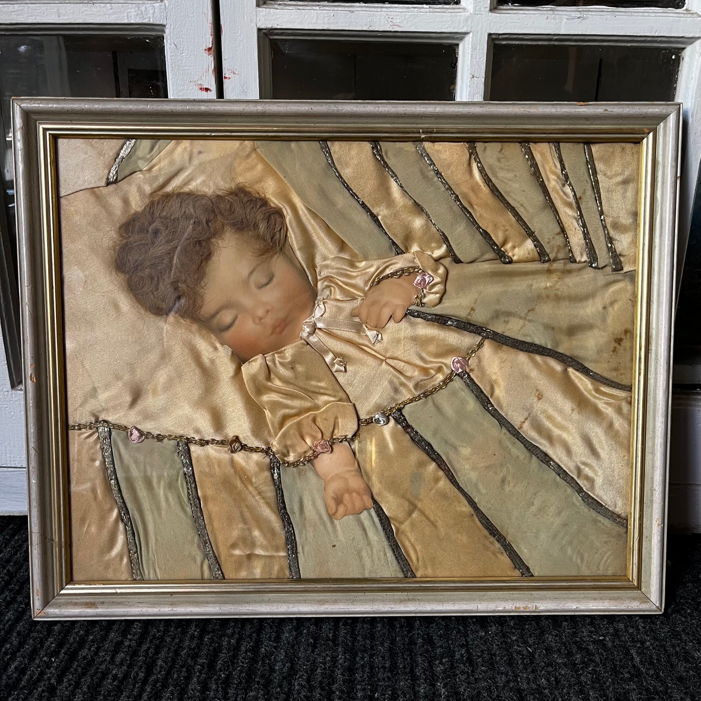Early 1900s Sleeping baby portrait made with real hair and silk.