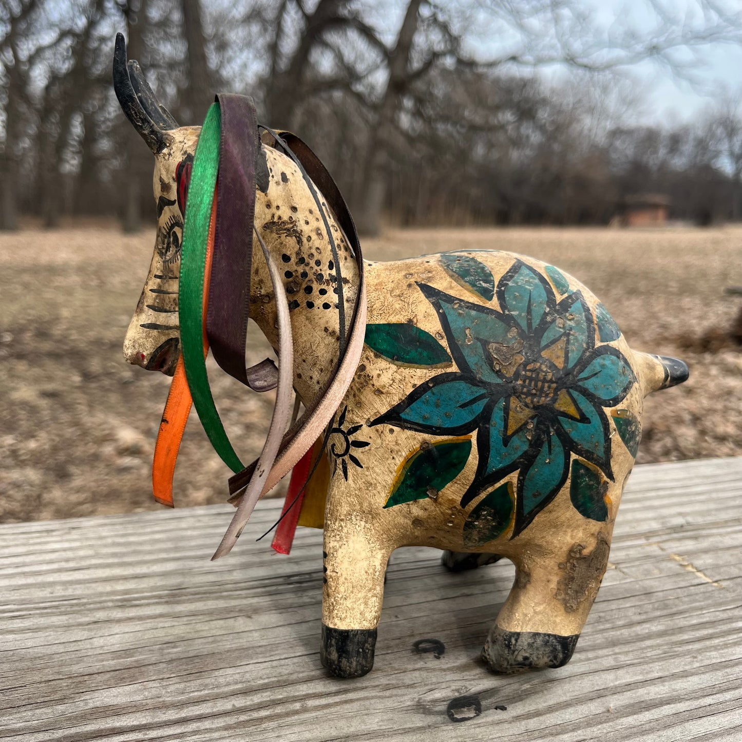 Hand crafted goat gourd maraca.