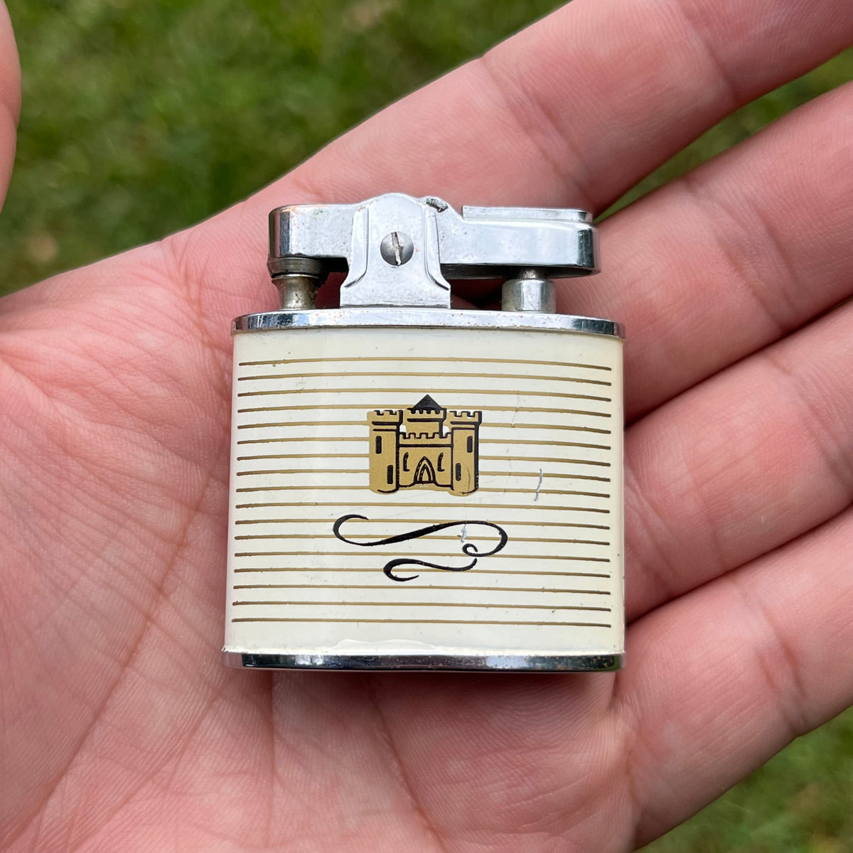 1960s Auer “Champion” white castle snap lighter.