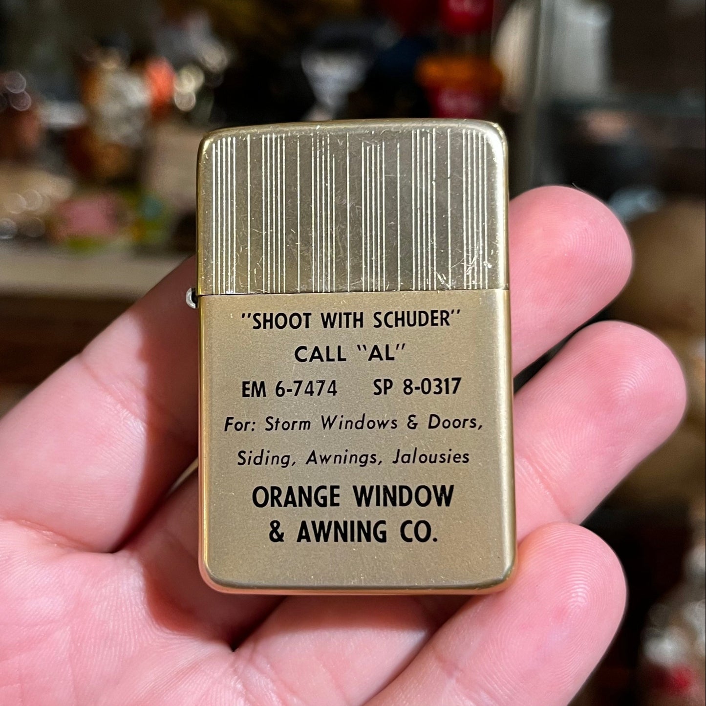Vintage orange window & awning co. lighter.