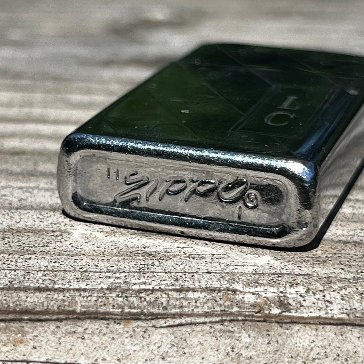 Vintage initial Zippo flip lighter.