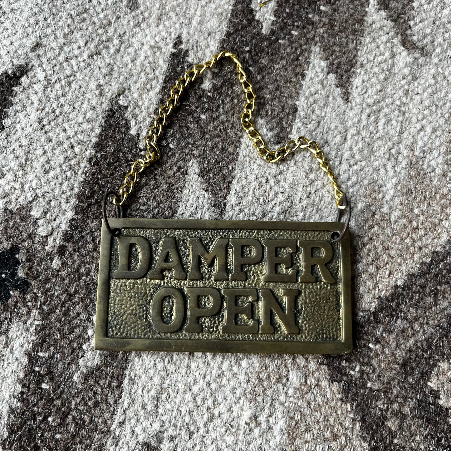Brass damper open/closed plaque.