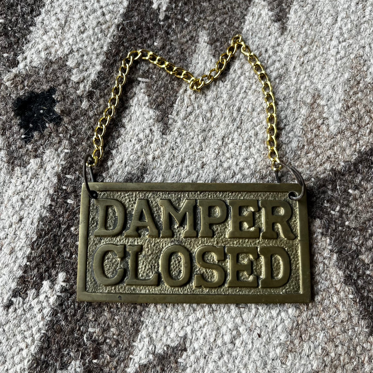 Brass damper open/closed plaque.