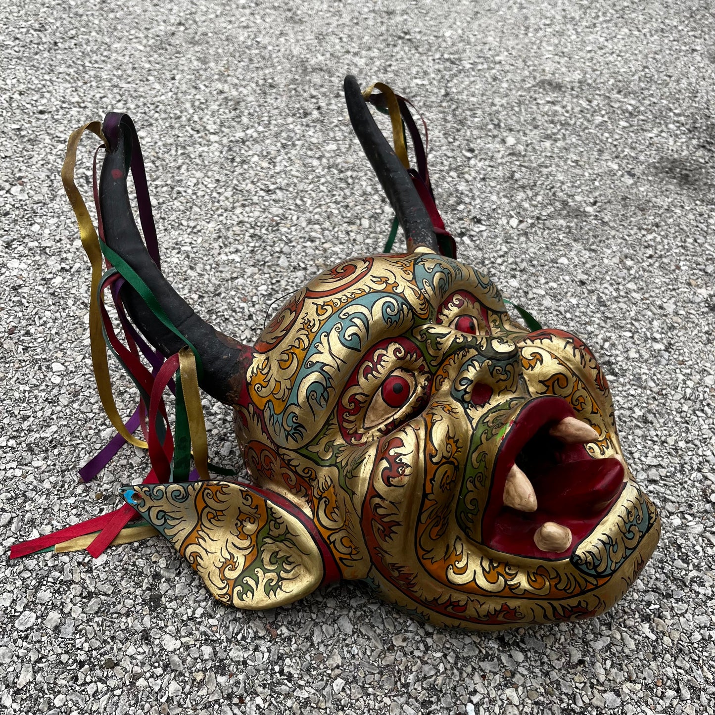 Modern hand crafted Diablo mask with ribbons.