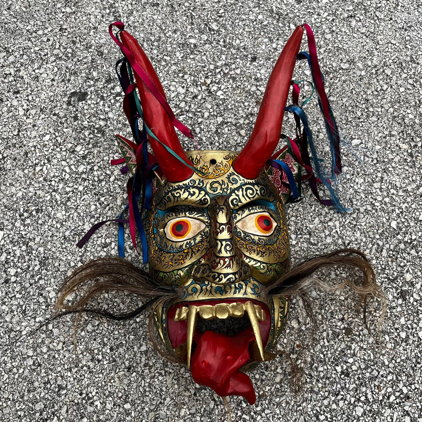 Large ceremonial Diablo mask with ribbons and horse hair.