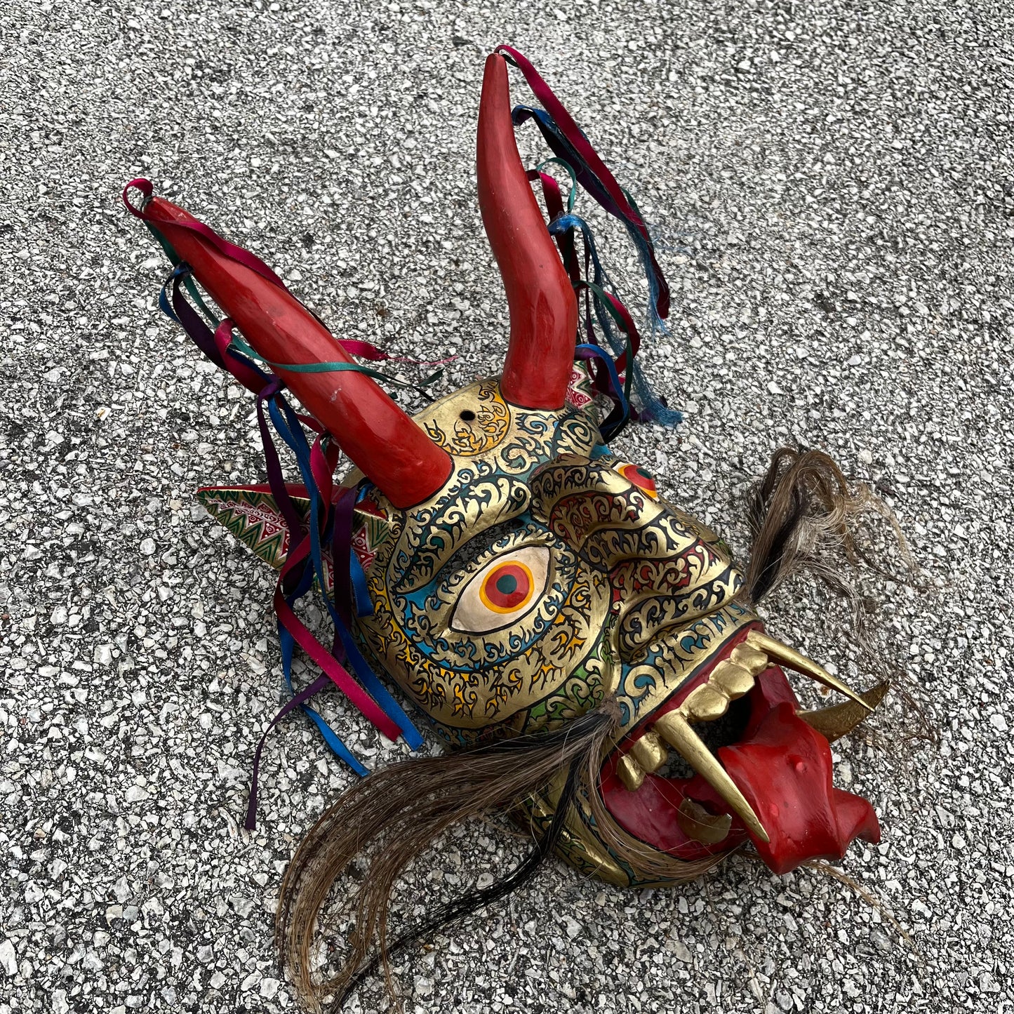 Large ceremonial Diablo mask with ribbons and horse hair.