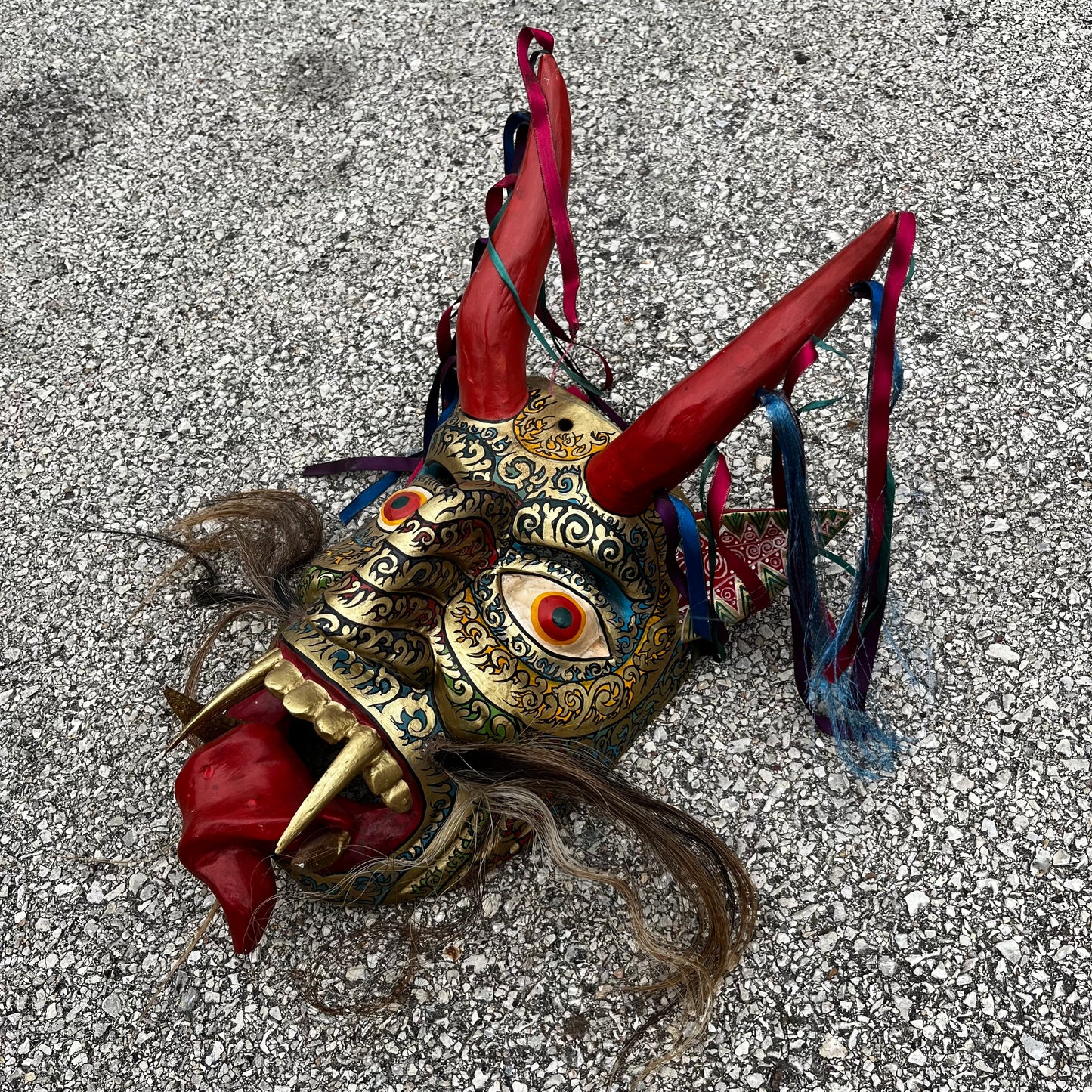 Large ceremonial Diablo mask with ribbons and horse hair.