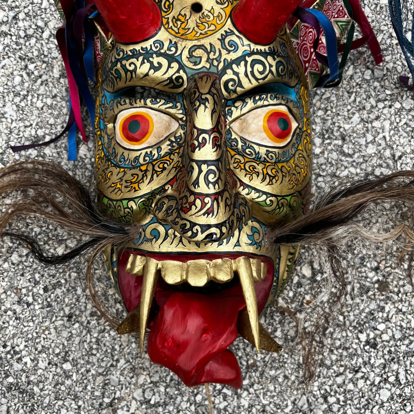 Large ceremonial Diablo mask with ribbons and horse hair.