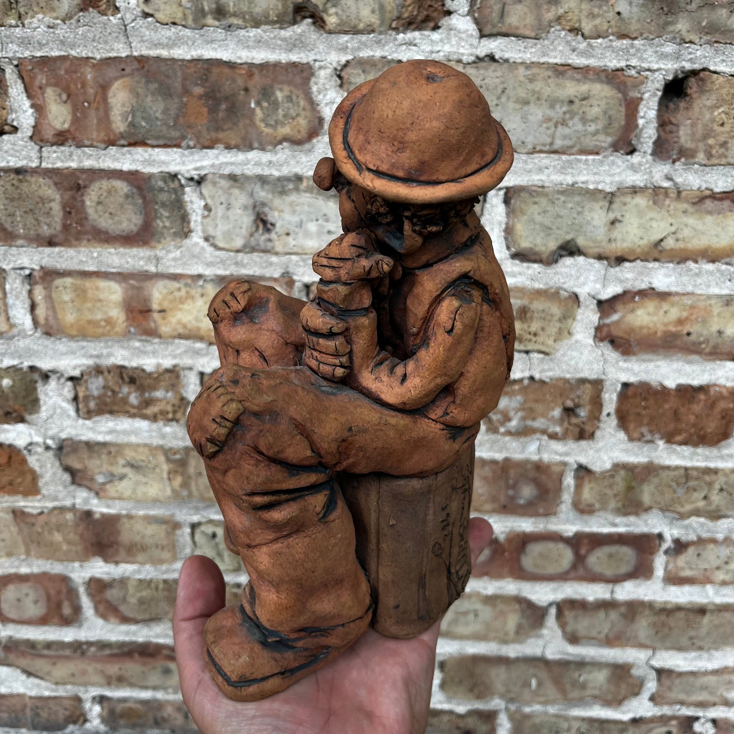 1987 Clay clown sculpture.
