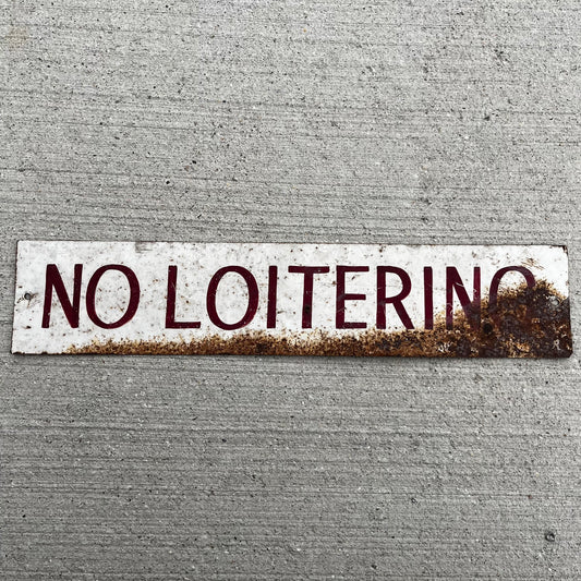 Vintage hand painted “No Loitering” tin sign.