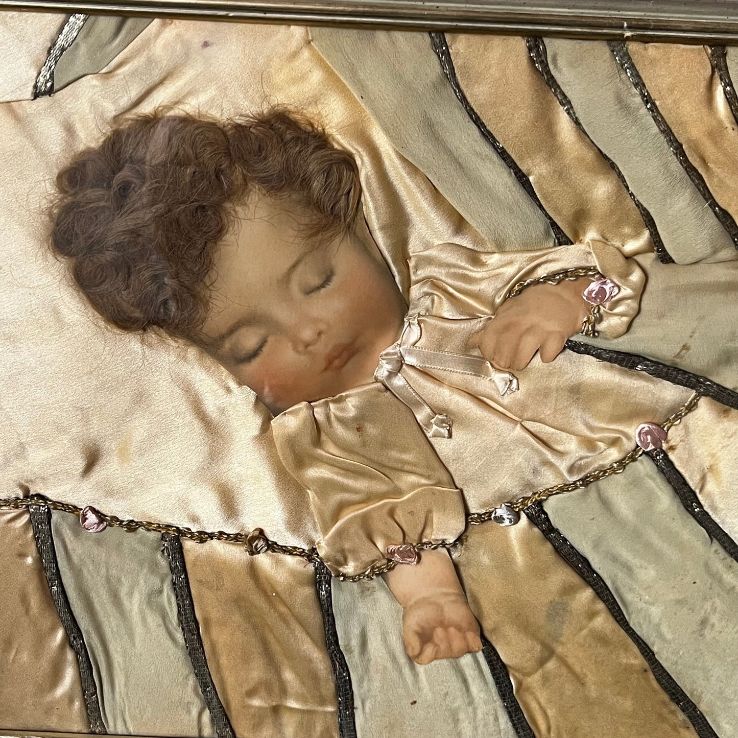 Early 1900s Sleeping baby portrait  made with real hair and silk.