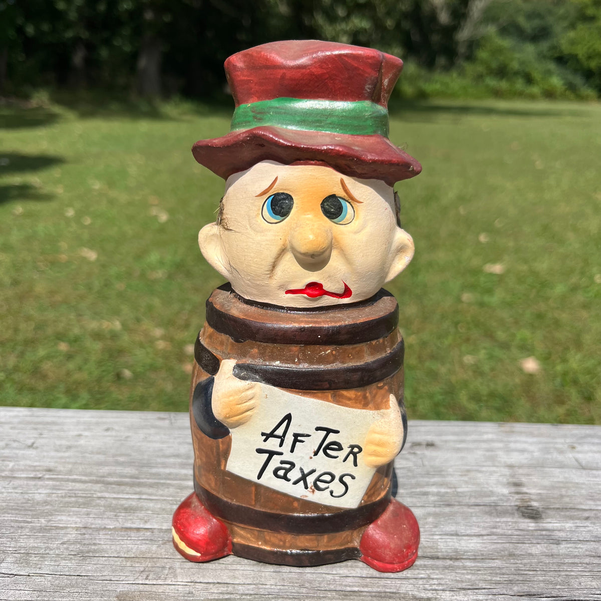Vintage ceramic barrel man coin bank.