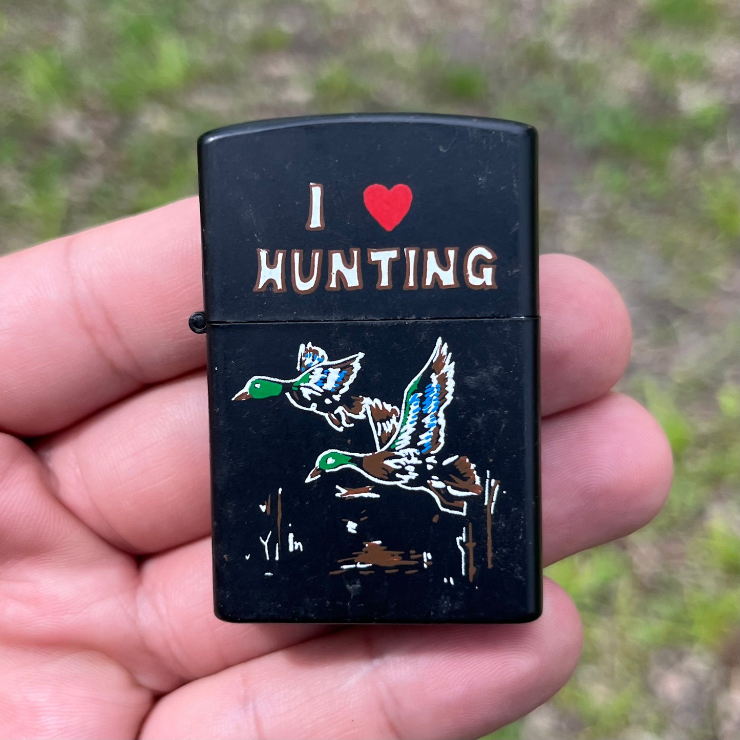 90s “I Love Hunting” flip lighter.