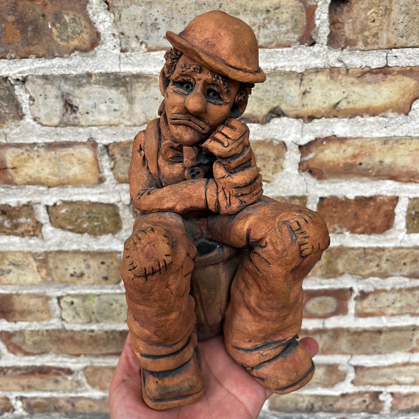 1987 Clay clown sculpture.