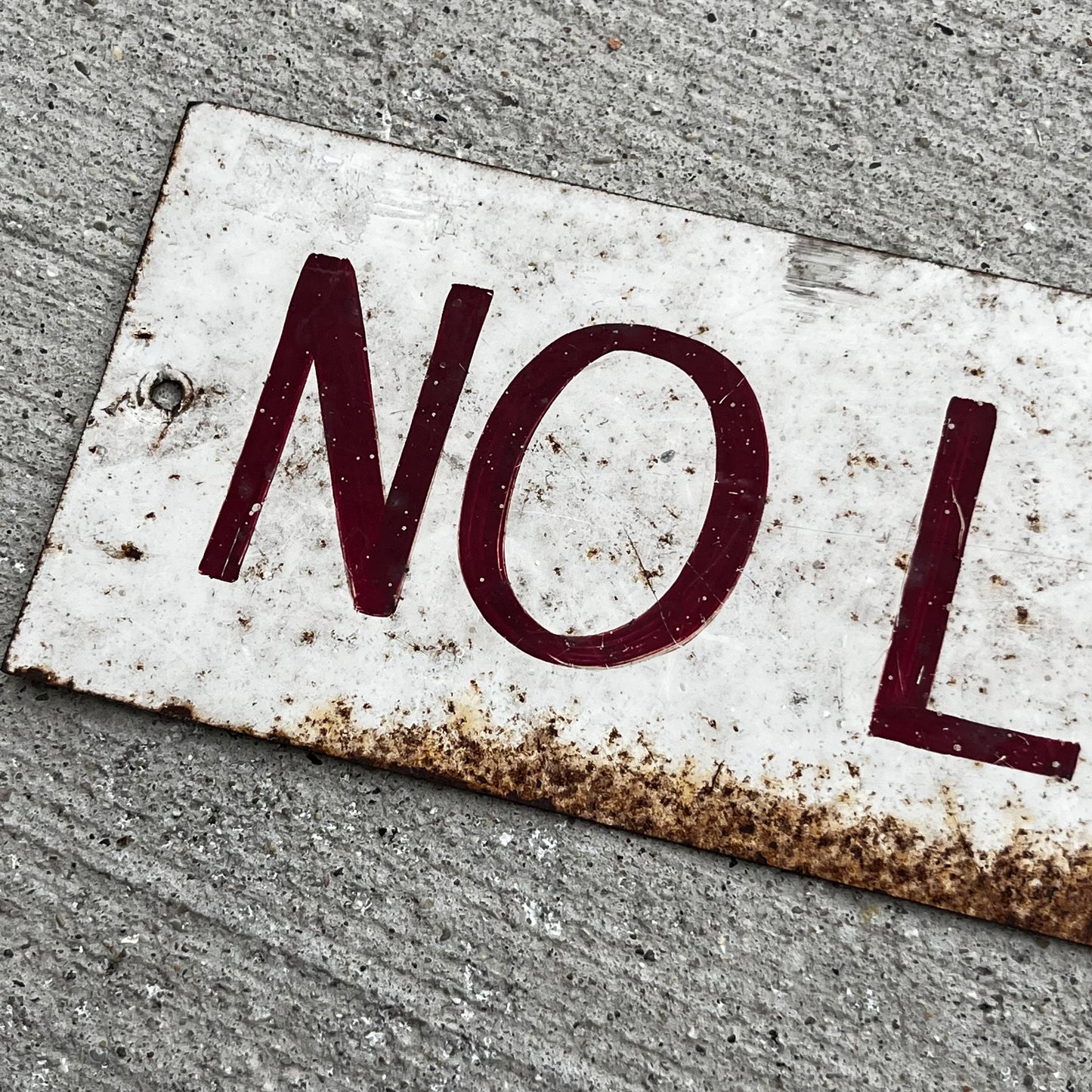 Vintage hand painted “No Loitering” tin sign.