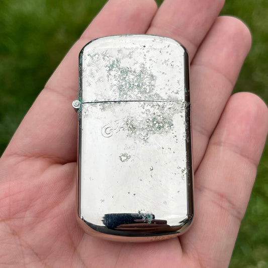 Vintage weathered Camel flip lighter.