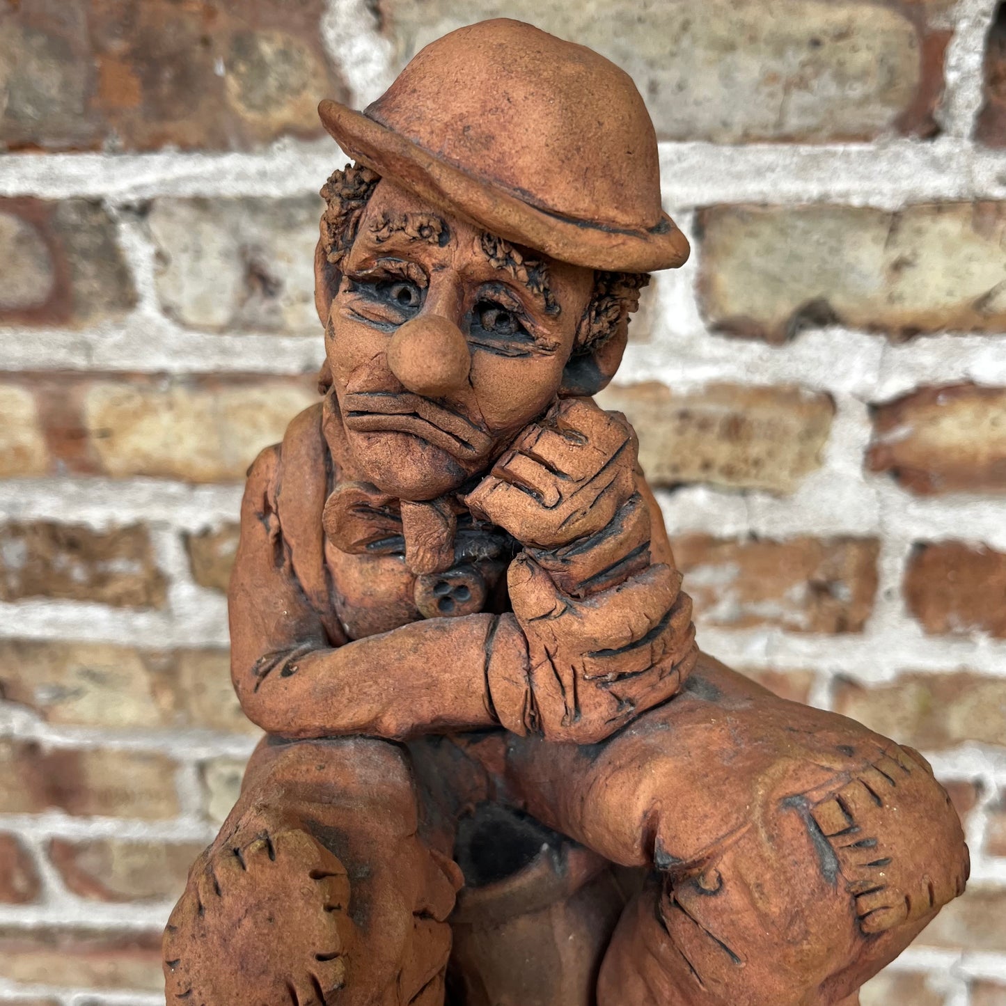 1987 Clay clown sculpture.