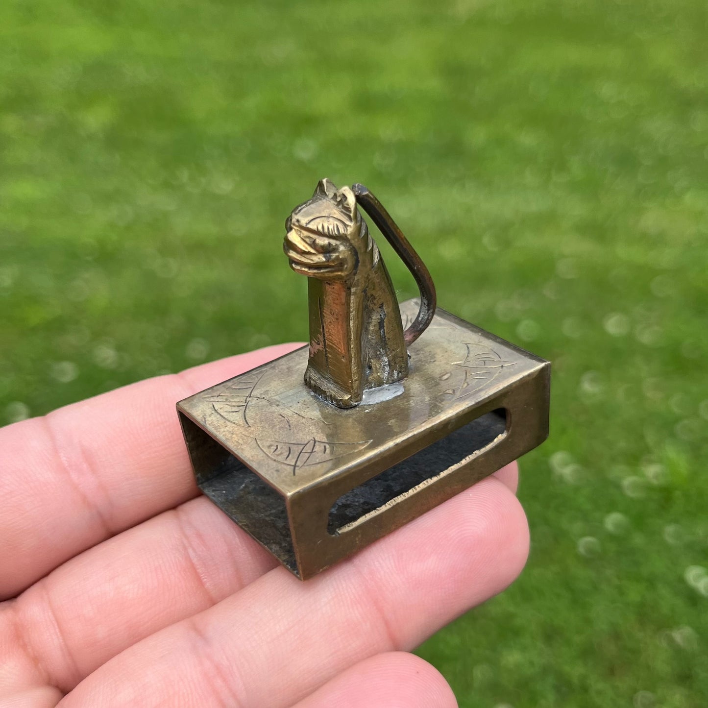 Vintage brass cat matchbook safe.
