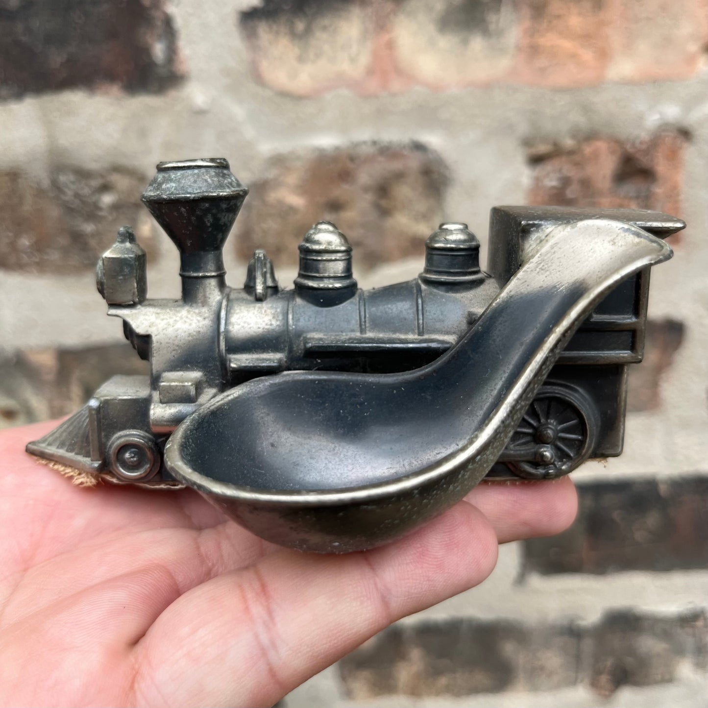 Vintage pewter train pipe holder.
