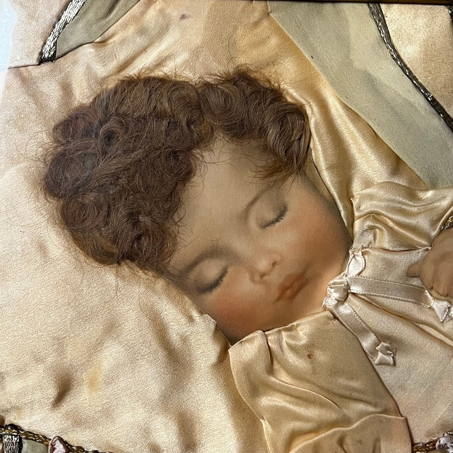 Early 1900s Sleeping baby portrait  made with real hair and silk.