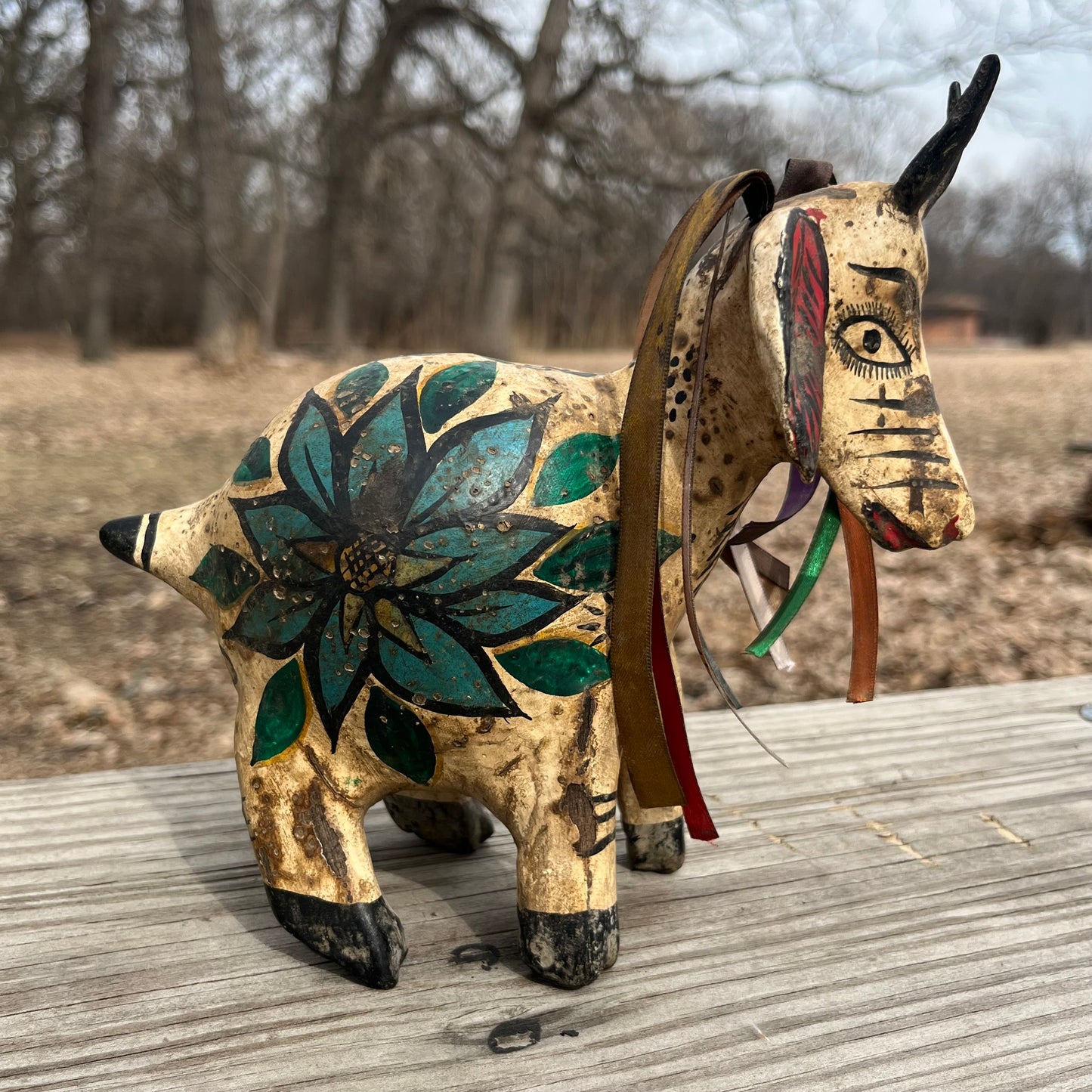 Hand crafted goat gourd maraca.