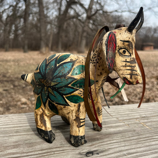 Hand crafted goat gourd maraca.