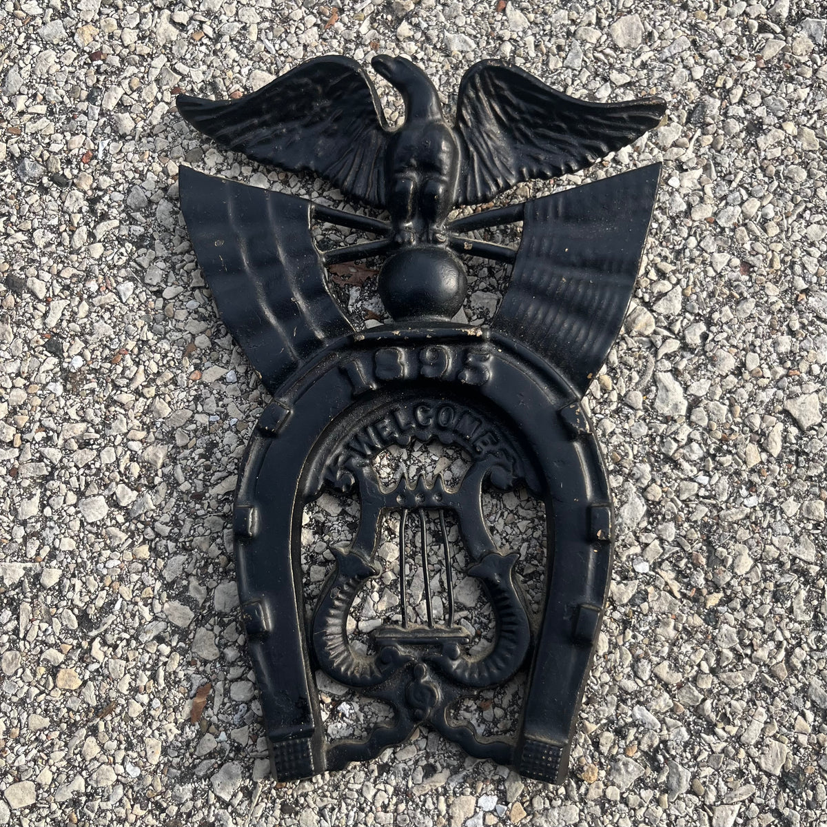 Vintage cast iron “Welcome” horseshoe.
