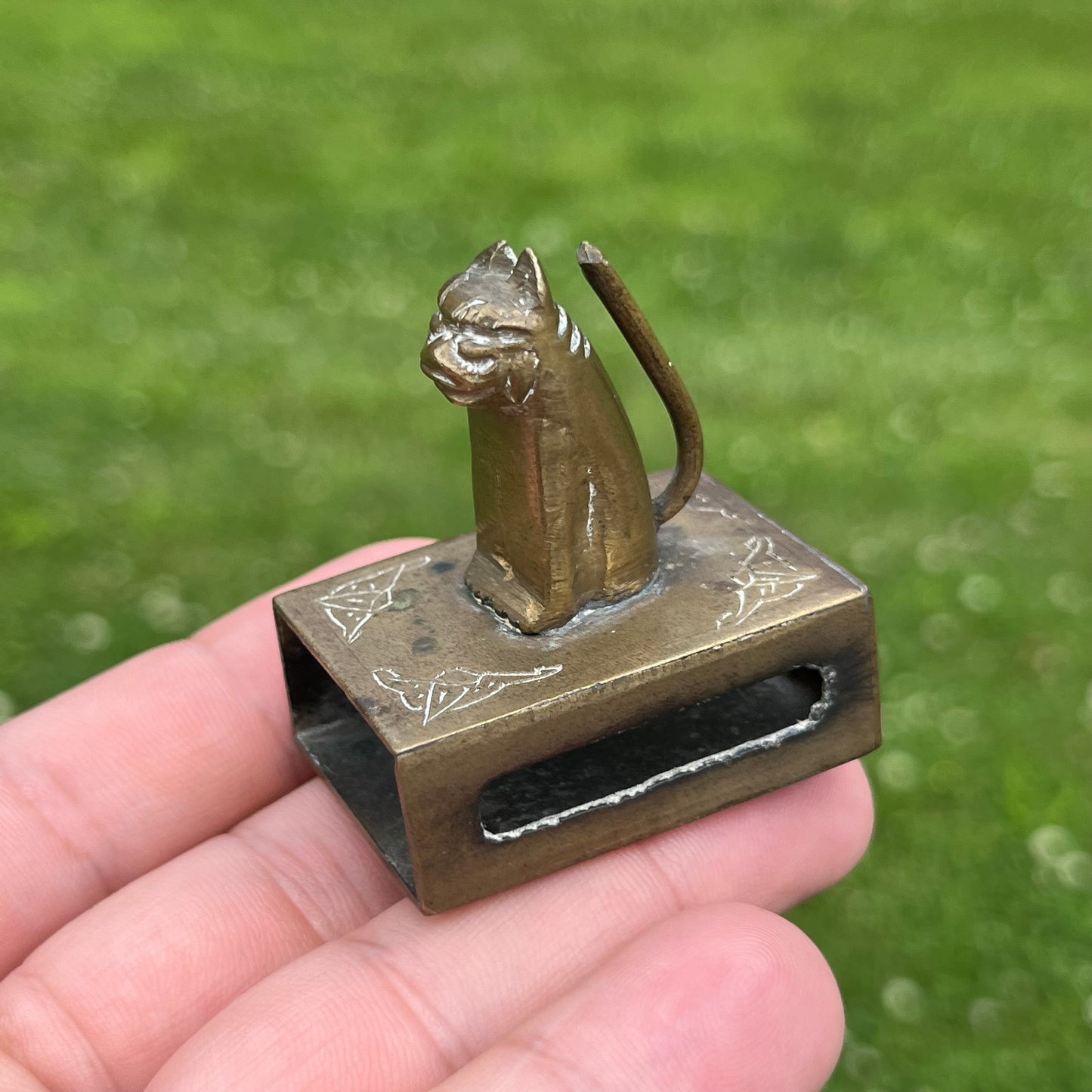 Vintage brass cat matchbook safe.