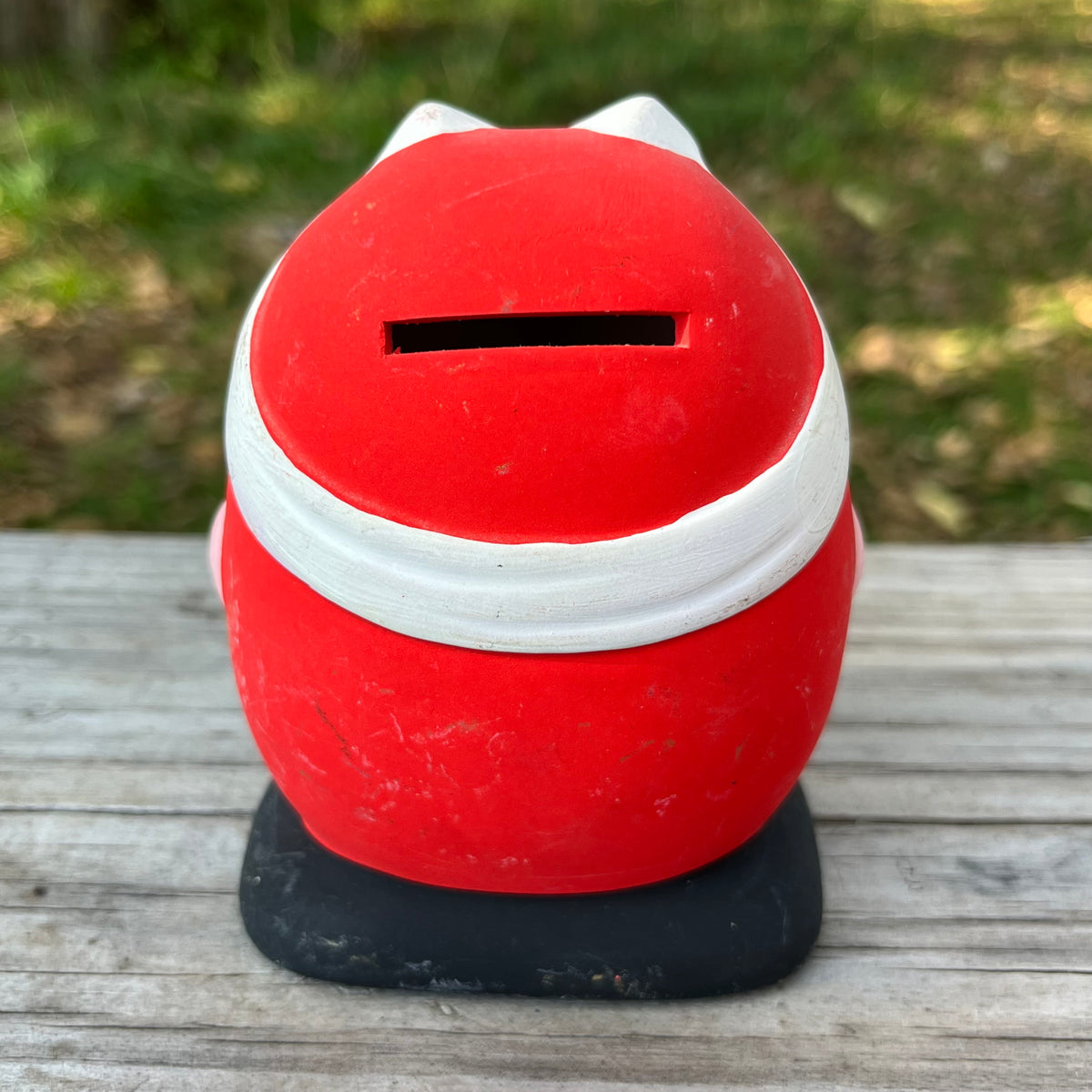 Vintage clay Hachimaki Daruma coin bank.