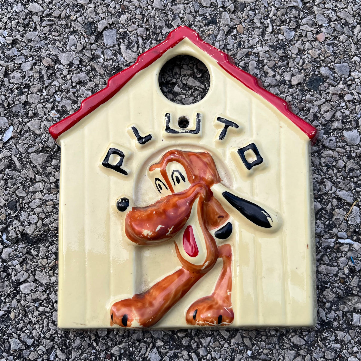 Vintage ceramic Pluto plaque.
