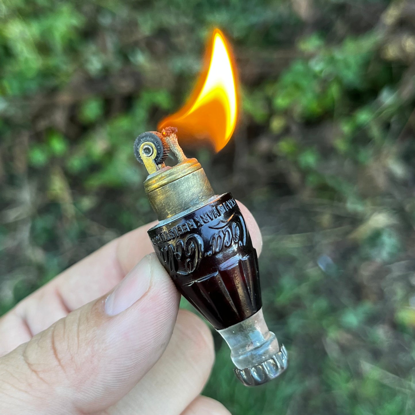 Vintage Coca-Cola bottle lighter.