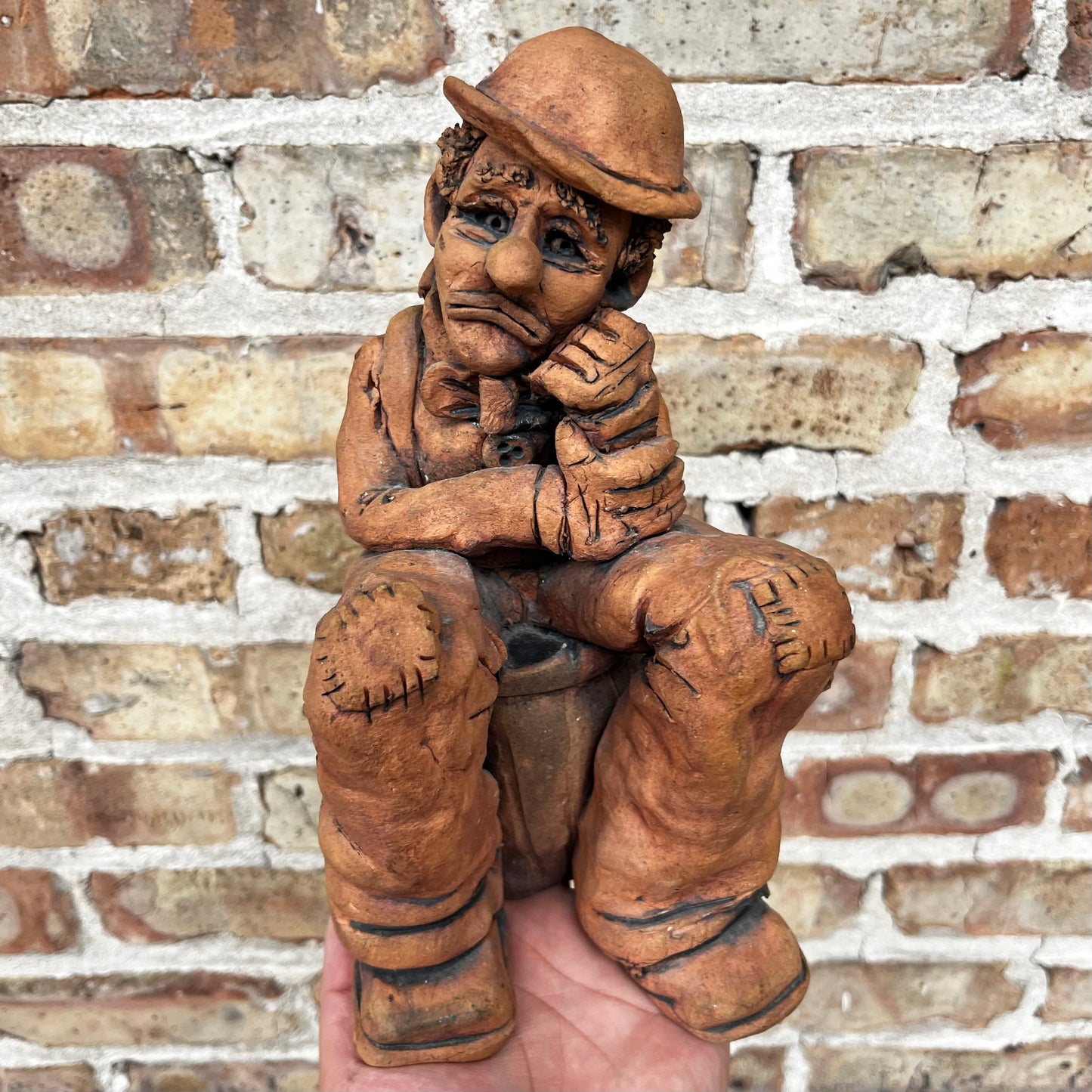1987 Clay clown sculpture.