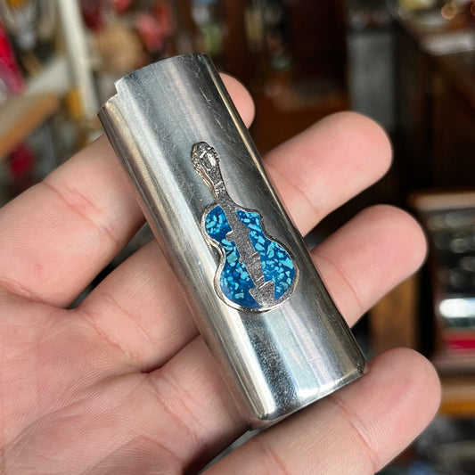 1980s Guitar lighter sleeve.