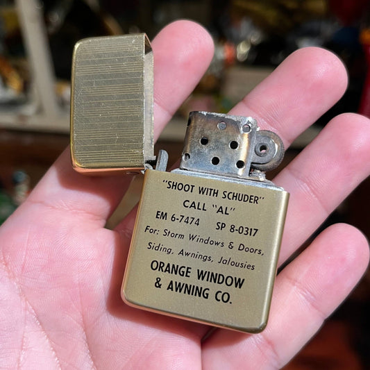 Vintage orange window & awning co. lighter.