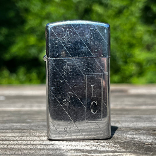 Vintage initial Zippo flip lighter.