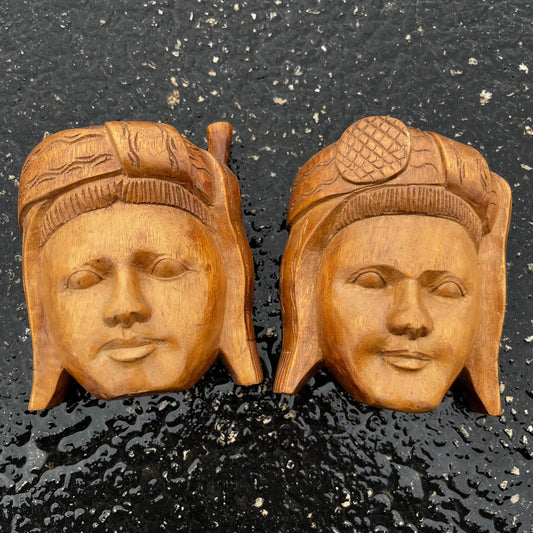 Vintage pair of wooden Ecuadorian masks.