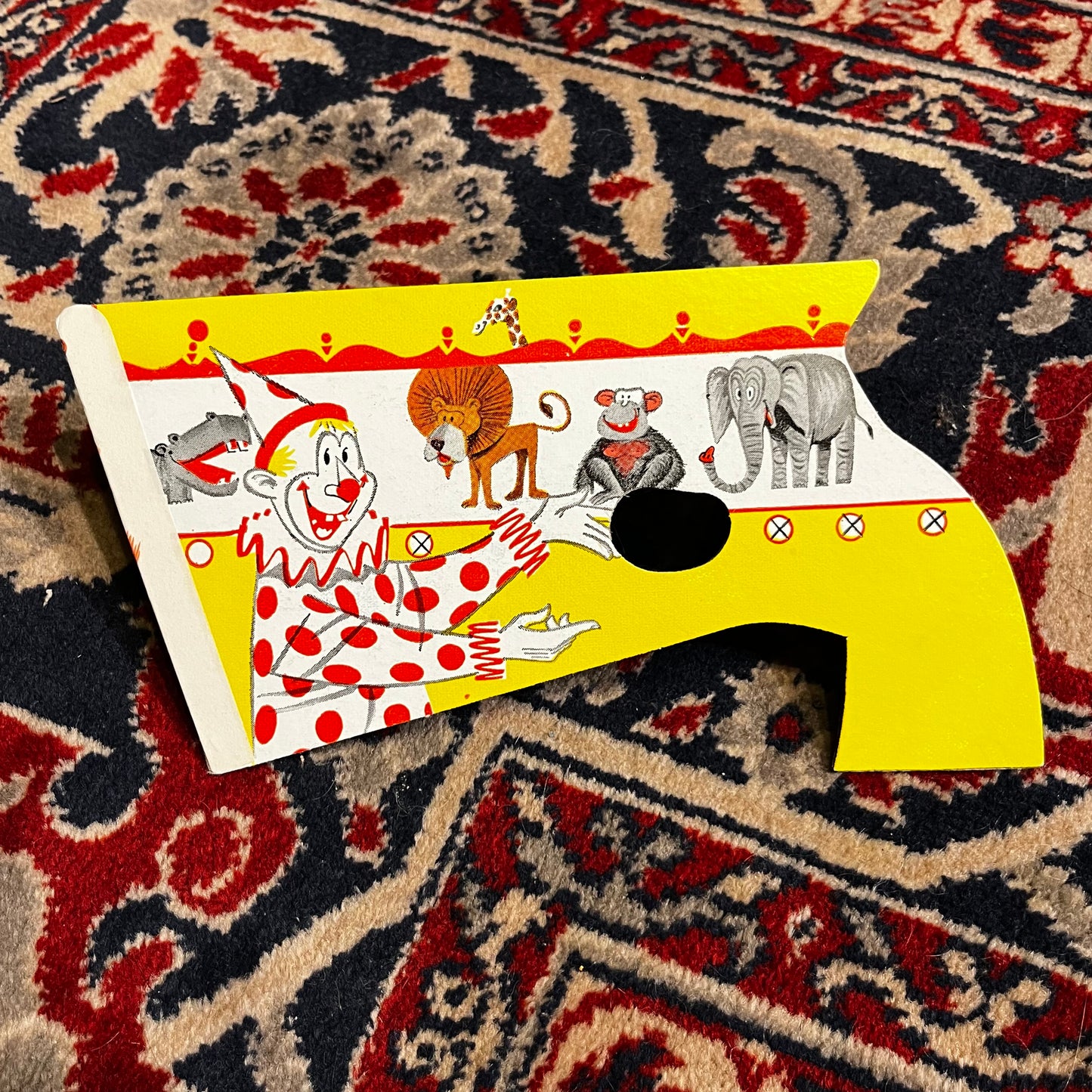 1954 Cardboard circus clown popping pistol.