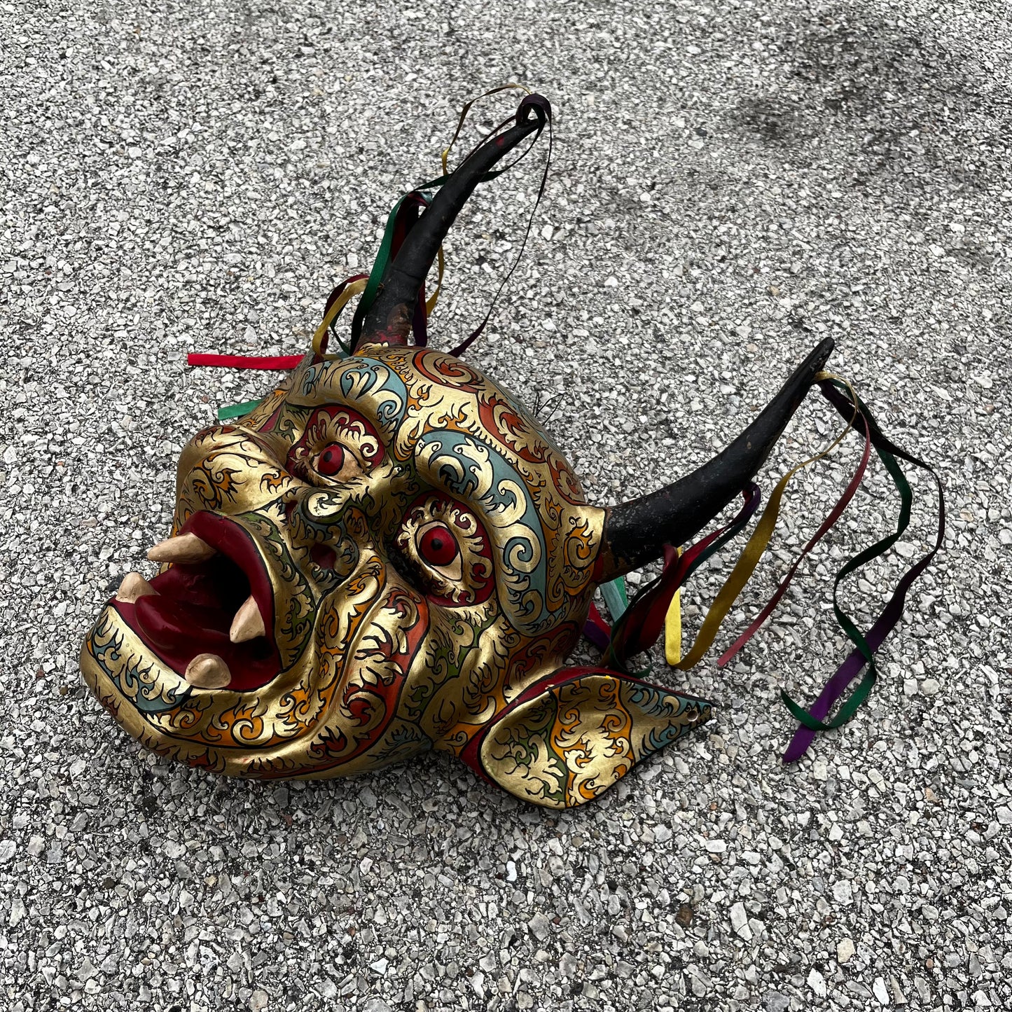 Modern hand crafted Diablo mask with ribbons.