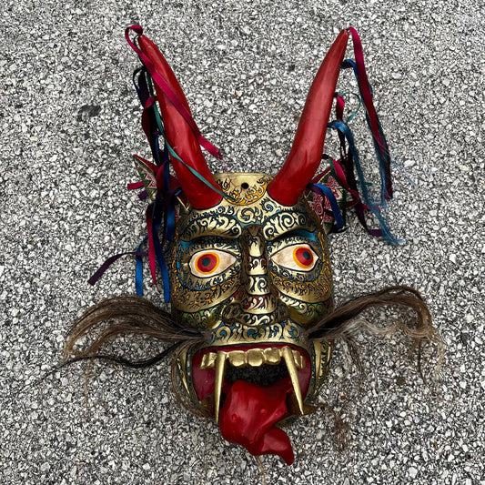 Large ceremonial Diablo mask with ribbons and horse hair.